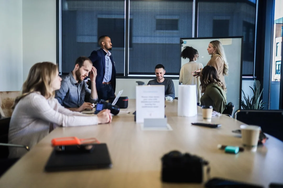 Hands discussing marketing strategy with charts in an office setting.